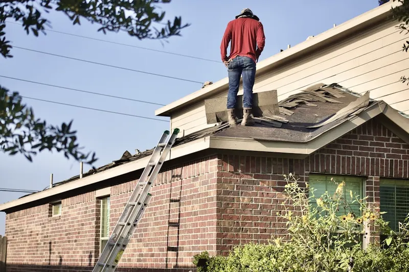 Professional roofer working on a residential roof in Canoga Park